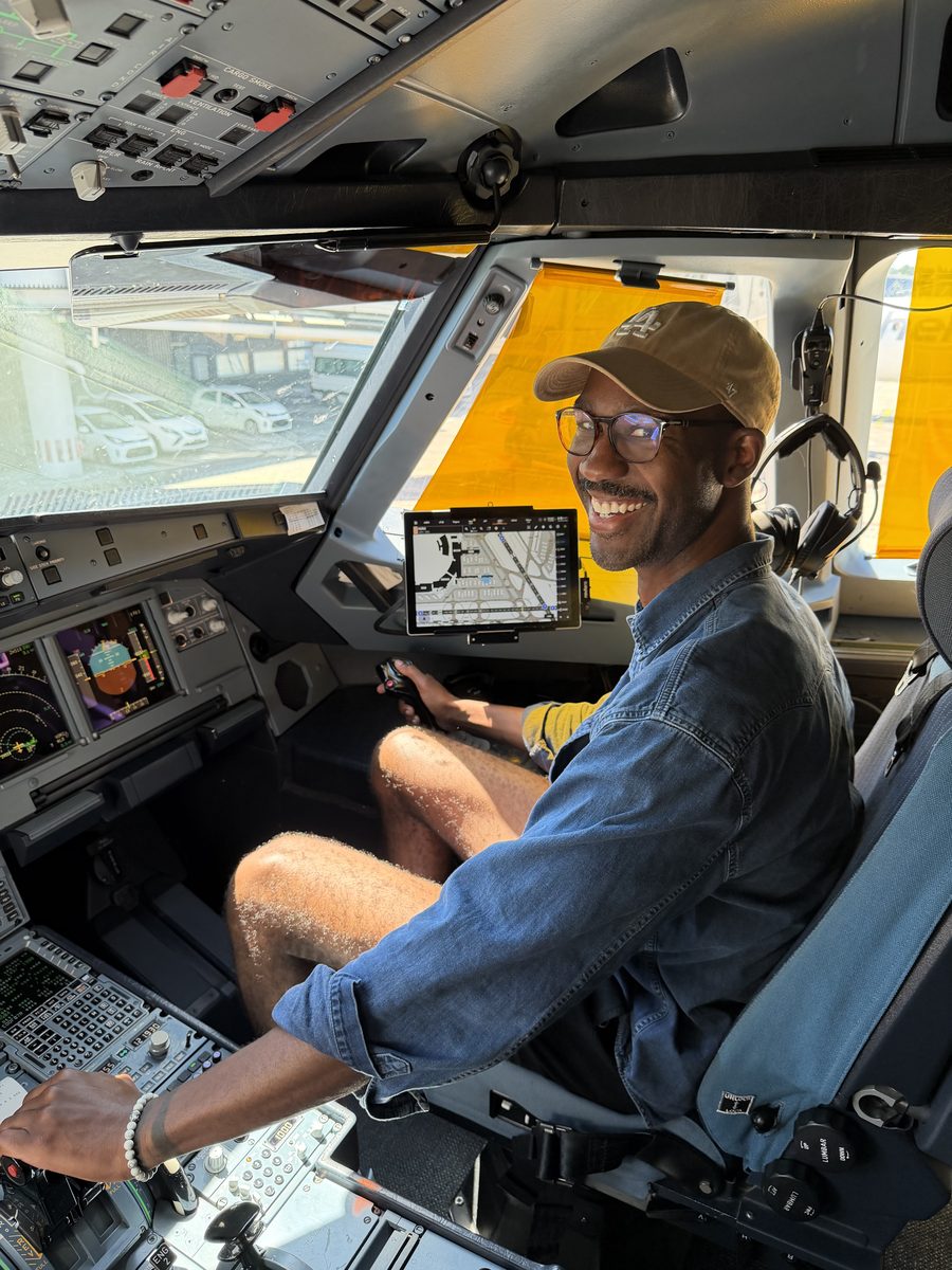 David, founder of LandedRio, in an airplane cockpit